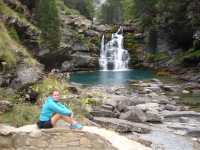 Walking resting at a waterfall in the Ordesa Canyon
